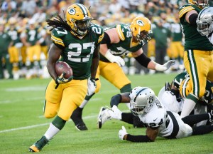 Aug 22, 2014; Green Bay, WI, USA; Green Bay Packers running back Eddie Lacy (27) gets around Oakland Raiders safety Charles Woodson (24) to gain yards in the 1st quarter during preseason game at Lambeau Field. Mandatory Credit: Benny Sieu-USA TODAY Sports ORG XMIT: USATSI-180648 ORIG FILE ID:  20140822_mje_bs5_142.jpg
